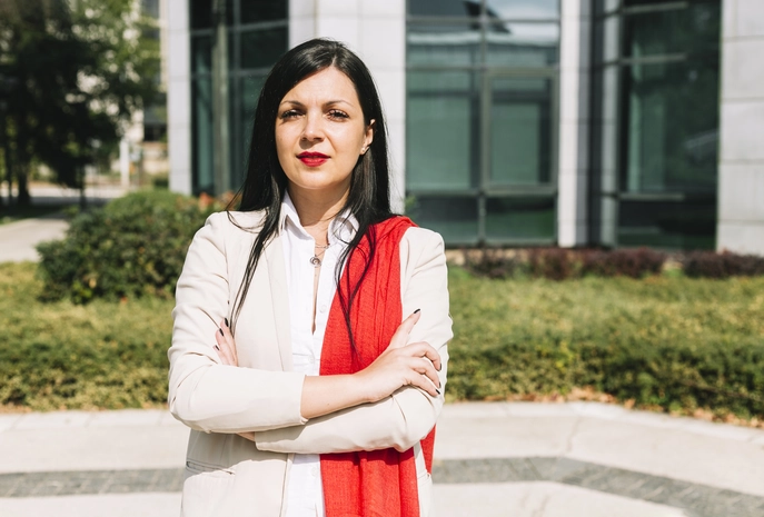 Indian businesswoman with crossed arms, symbolizing confidence and professional growth.